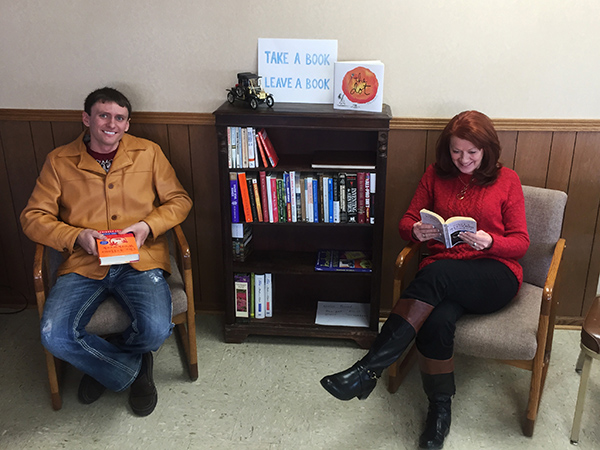 Heath Rost and Barb Peterson enjoying a good read at Rost Motor